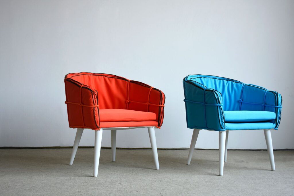 Modern orange and blue chairs against a minima