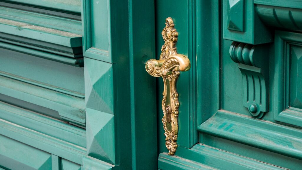 Close-up of an ornate brass door handle on a d