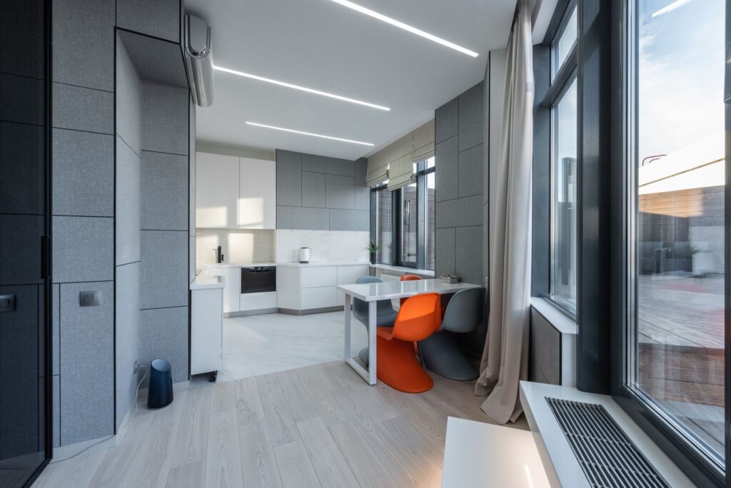 Interior of stylish light flat with table and